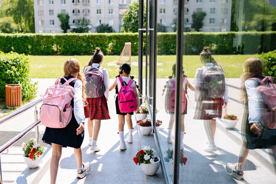 Students arriving at an elementary school on the first day