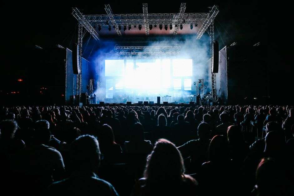 Crowd of people enjoying a free outdoor evening concert at a downtown street party