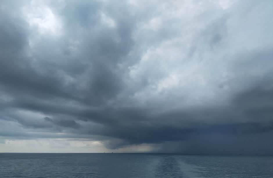 Dark storm clouds over a coastal city street