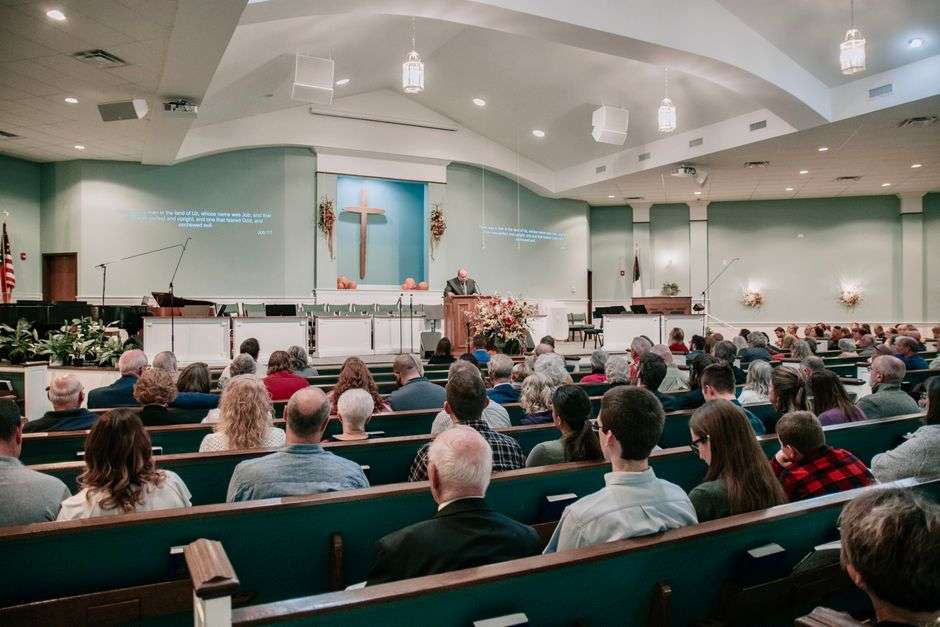 Congregation members gather during a worship service at a Baptist church