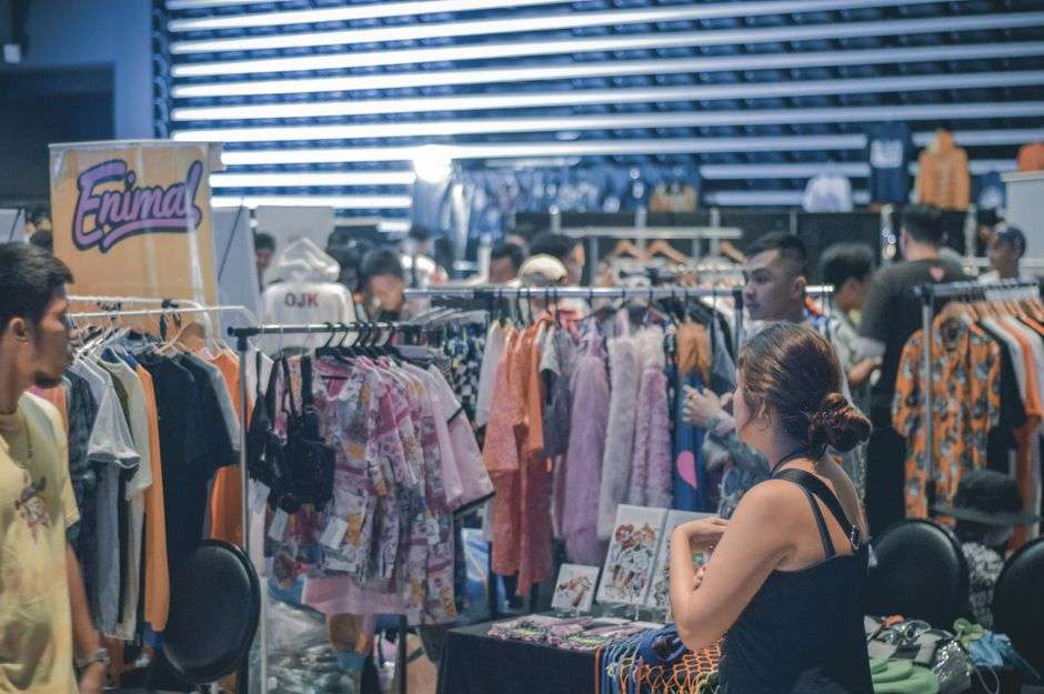 Shoppers browse vendor booths at a charity shopping event