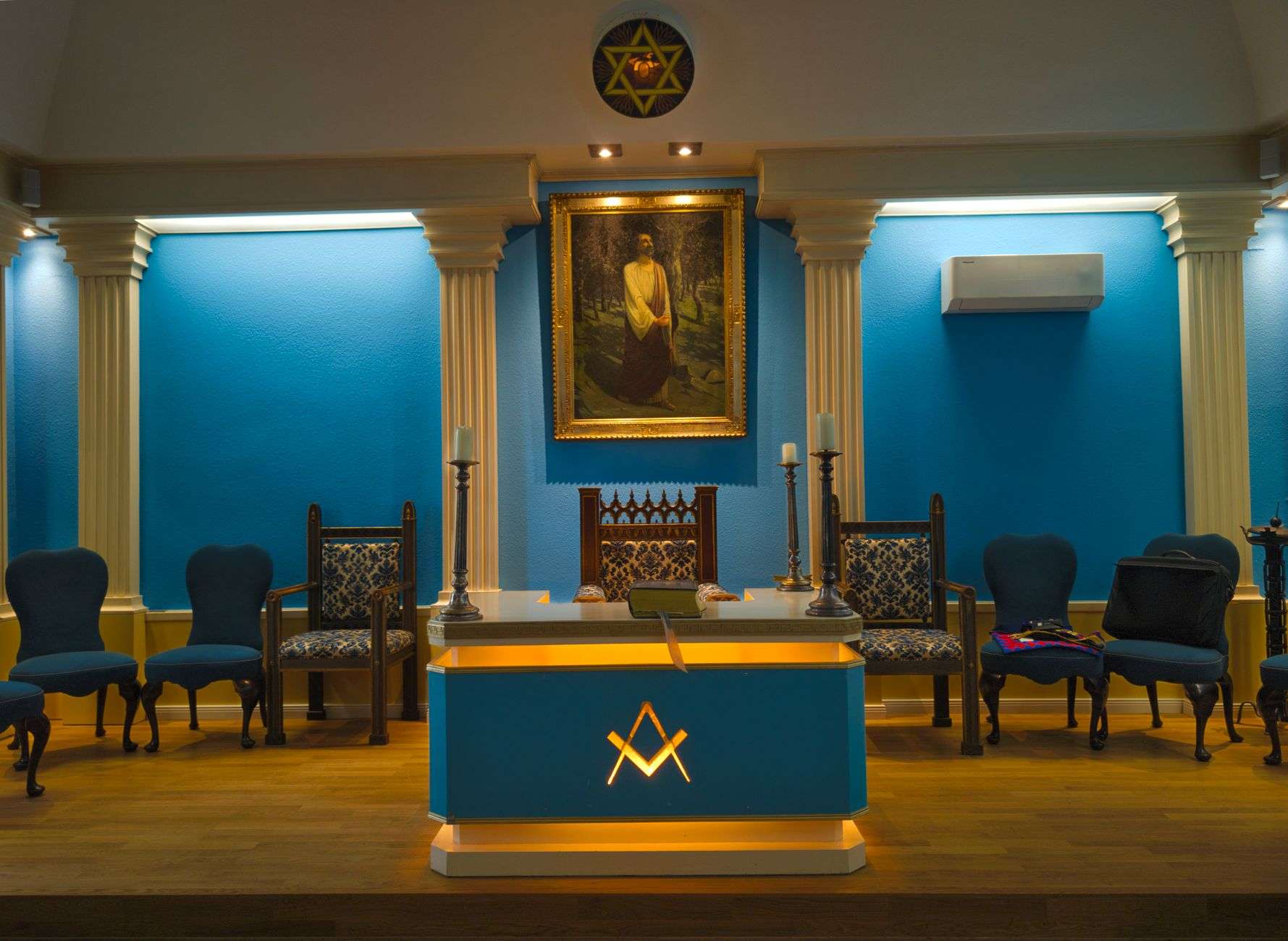 Interior of a Masonic lodge meeting room with ceremonial seating