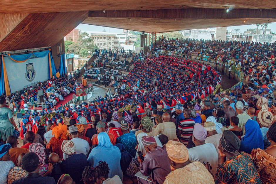 Graduates seated in caps and gowns during a university commencement