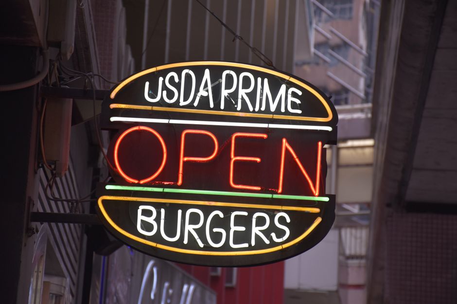 A restaurant with lights on and open sign after severe weather