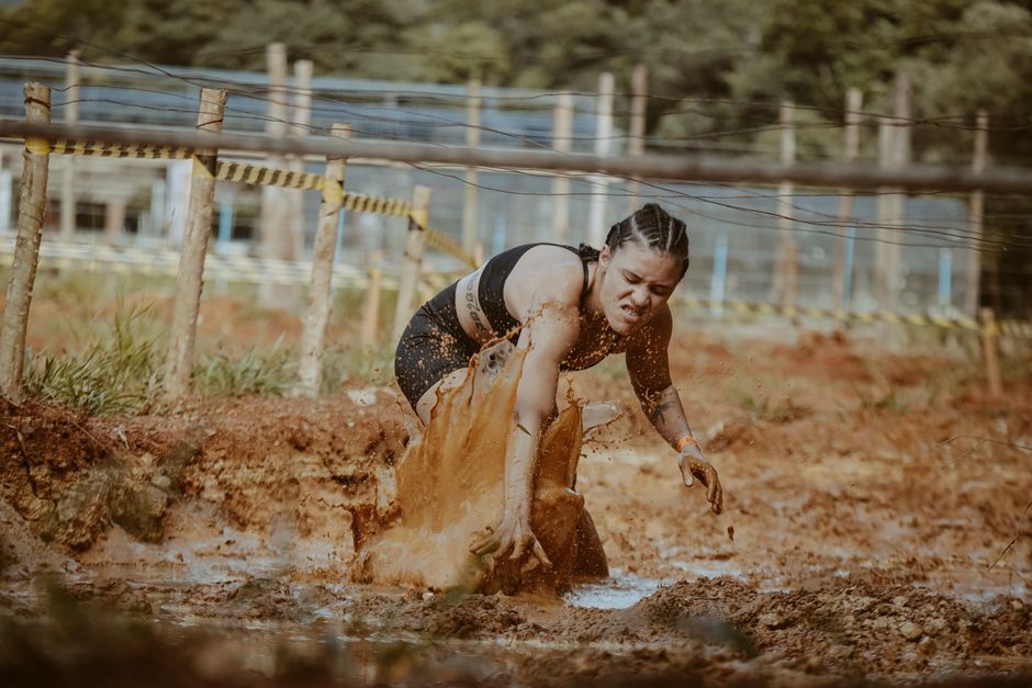 Runners tackling an obstacle during a Spartan-style obstacle course race