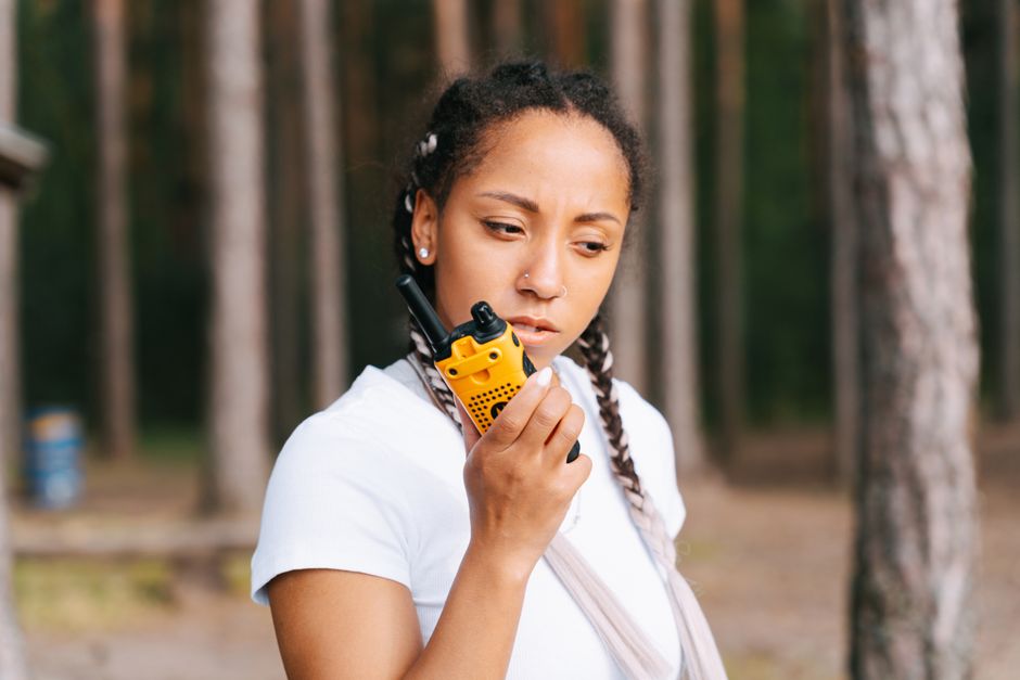 Public safety officer using handheld radio communication equipment on a college campus