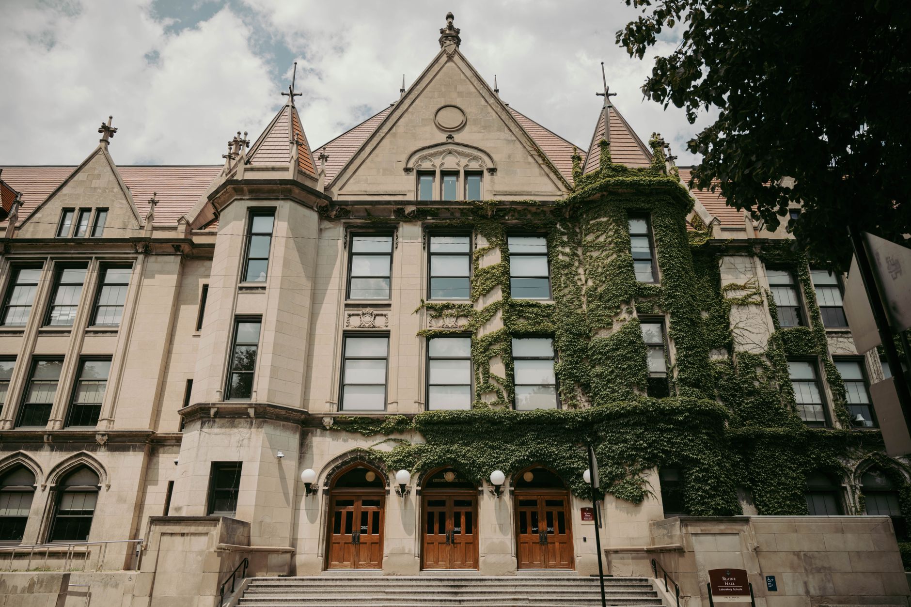 Historic college campus building with trees
