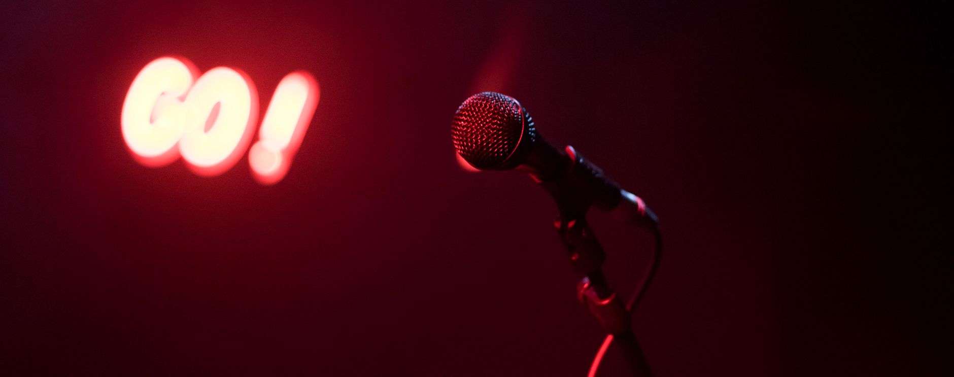 Microphone on a spotlighted stage before a stand-up comedy show