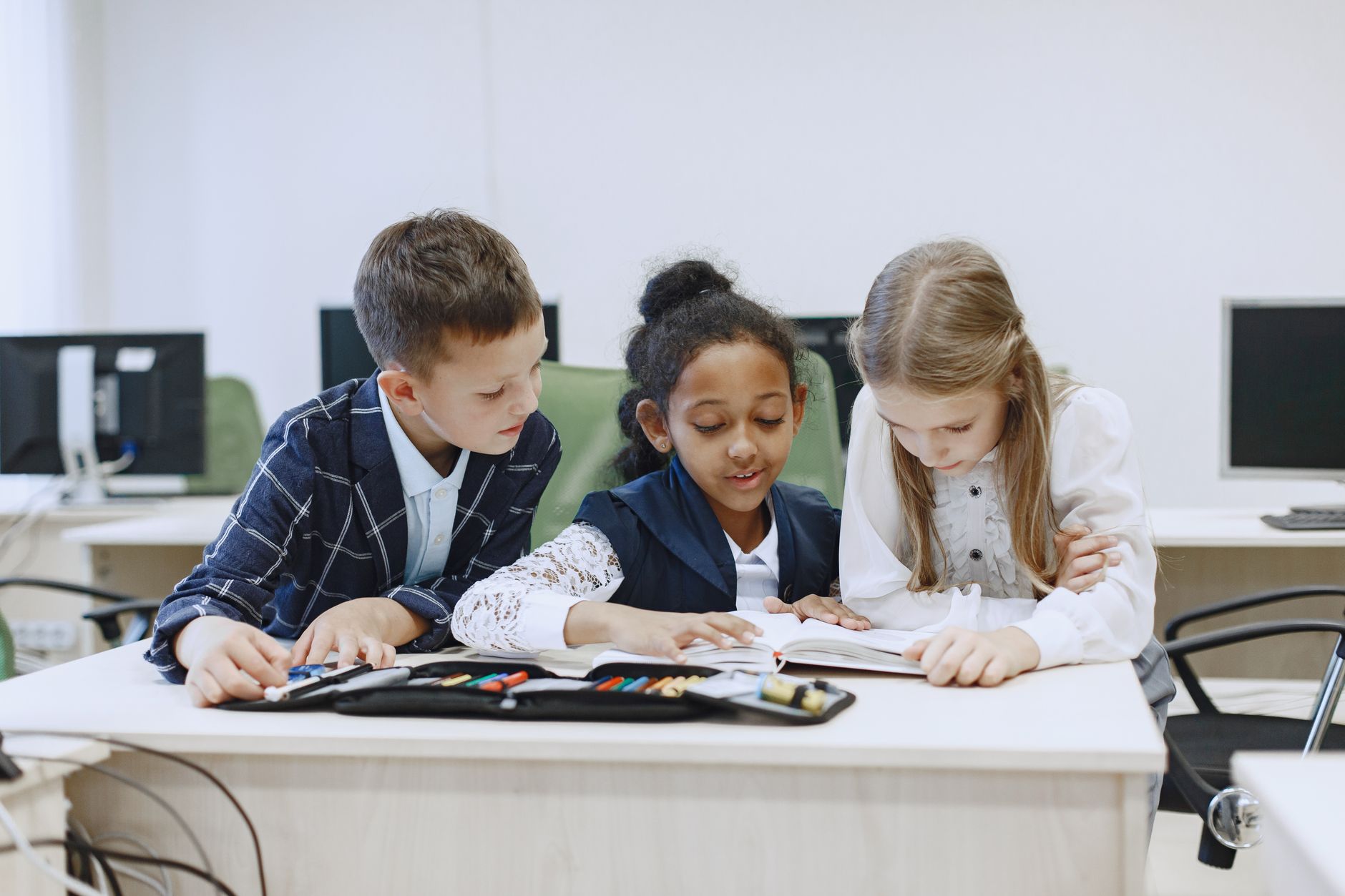 Elementary school children holding books in a classroom
