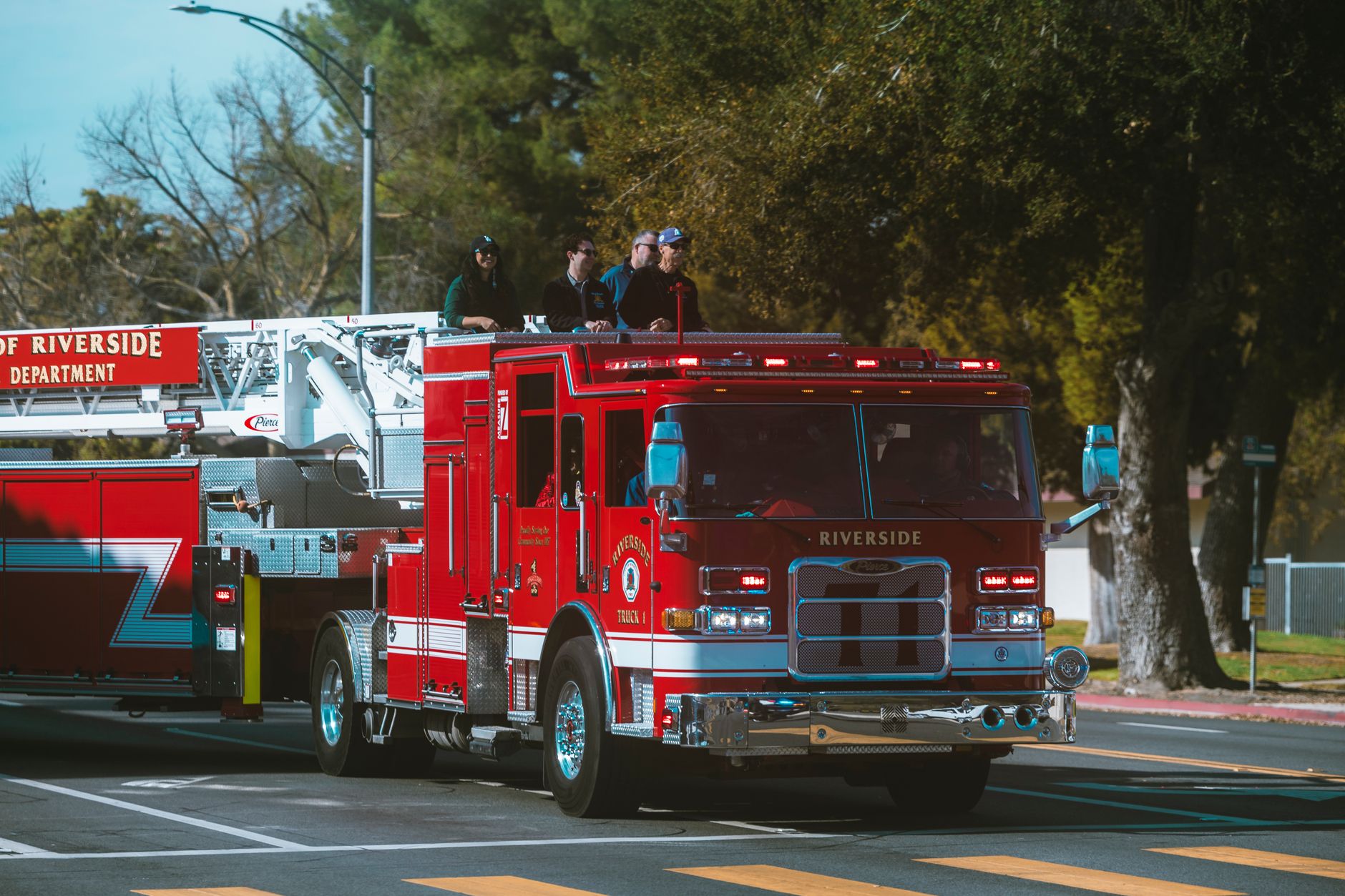 A firefighter standing beside a red fire engine