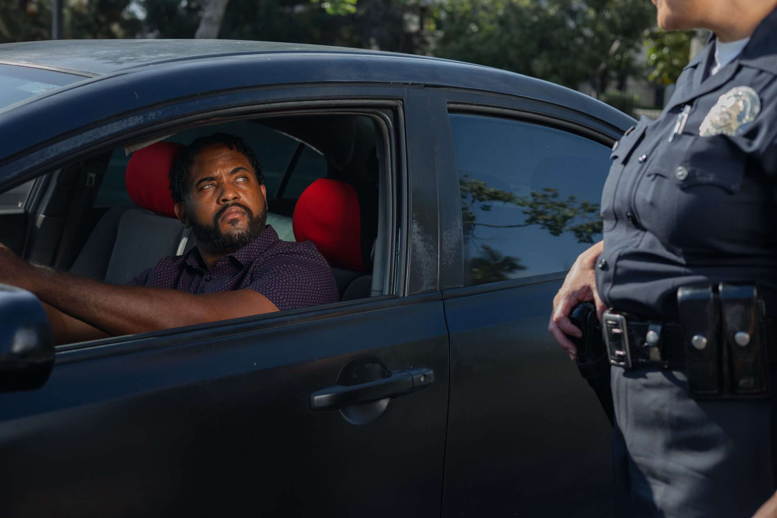 Police officer handing a traffic citation to a driver during a stop