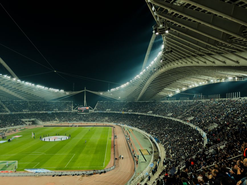 Large crowd filling stadium seats at night