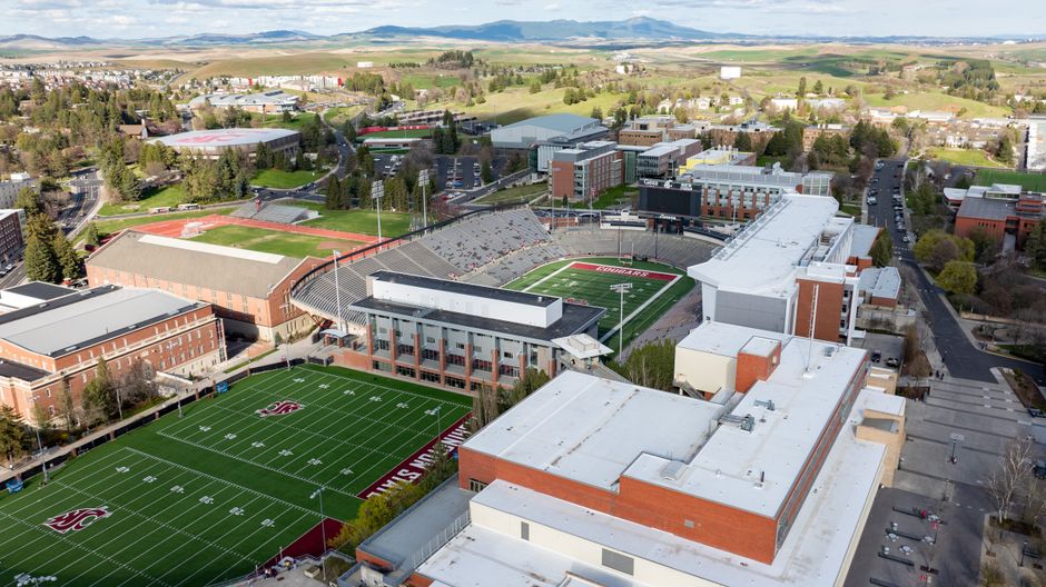 Students near a college football stadium parking lot
