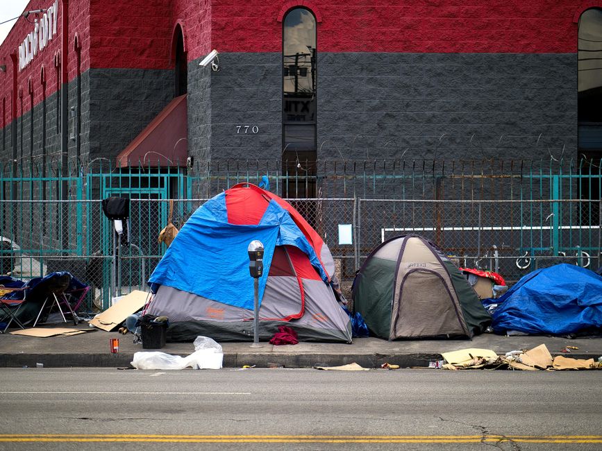 A person sitting outside a downtown day center for the homeless