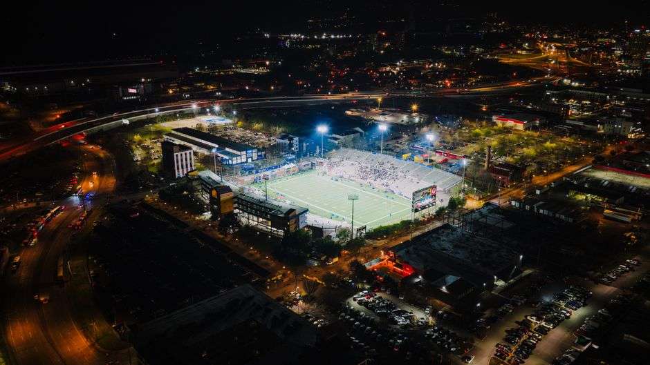 A brightly lit football stadium at night during a high school championship game