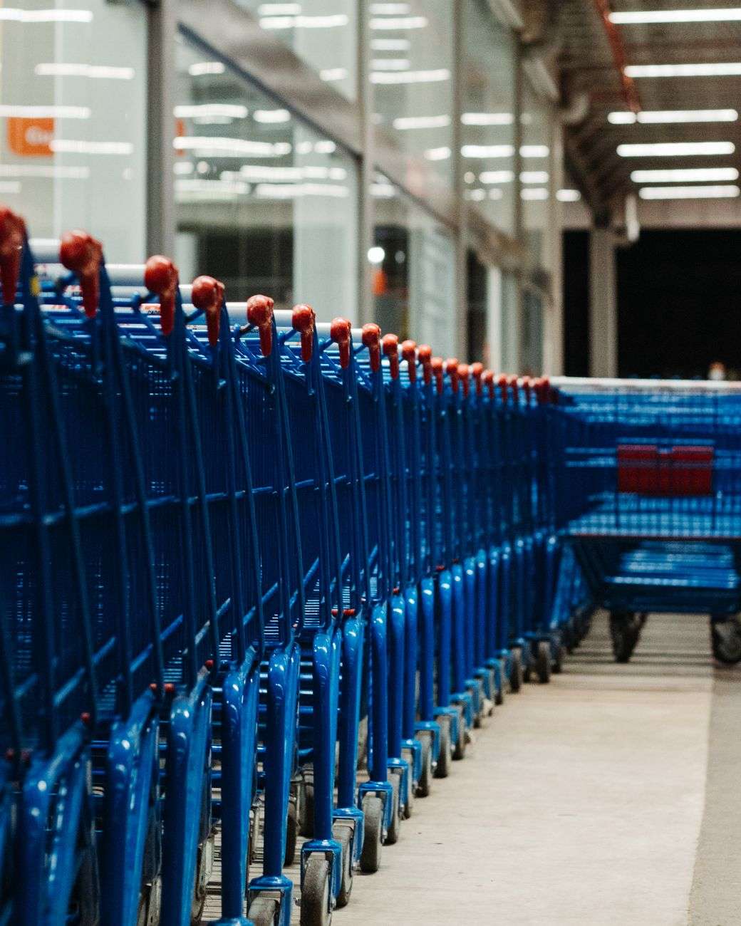 Row of shopping carts near a retail storefront