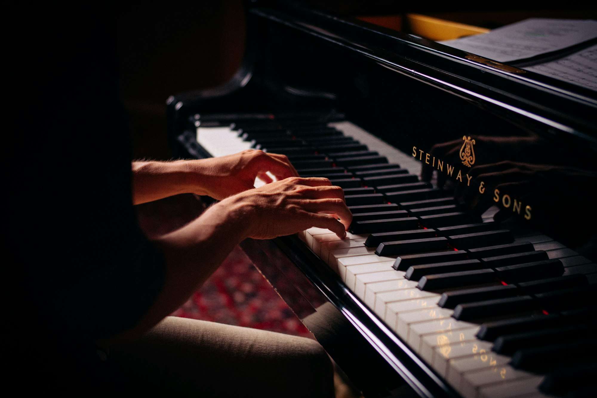 A jazz pianist playing a piano, evoking the style Mobile-born musician Ward Swingle helped popularize