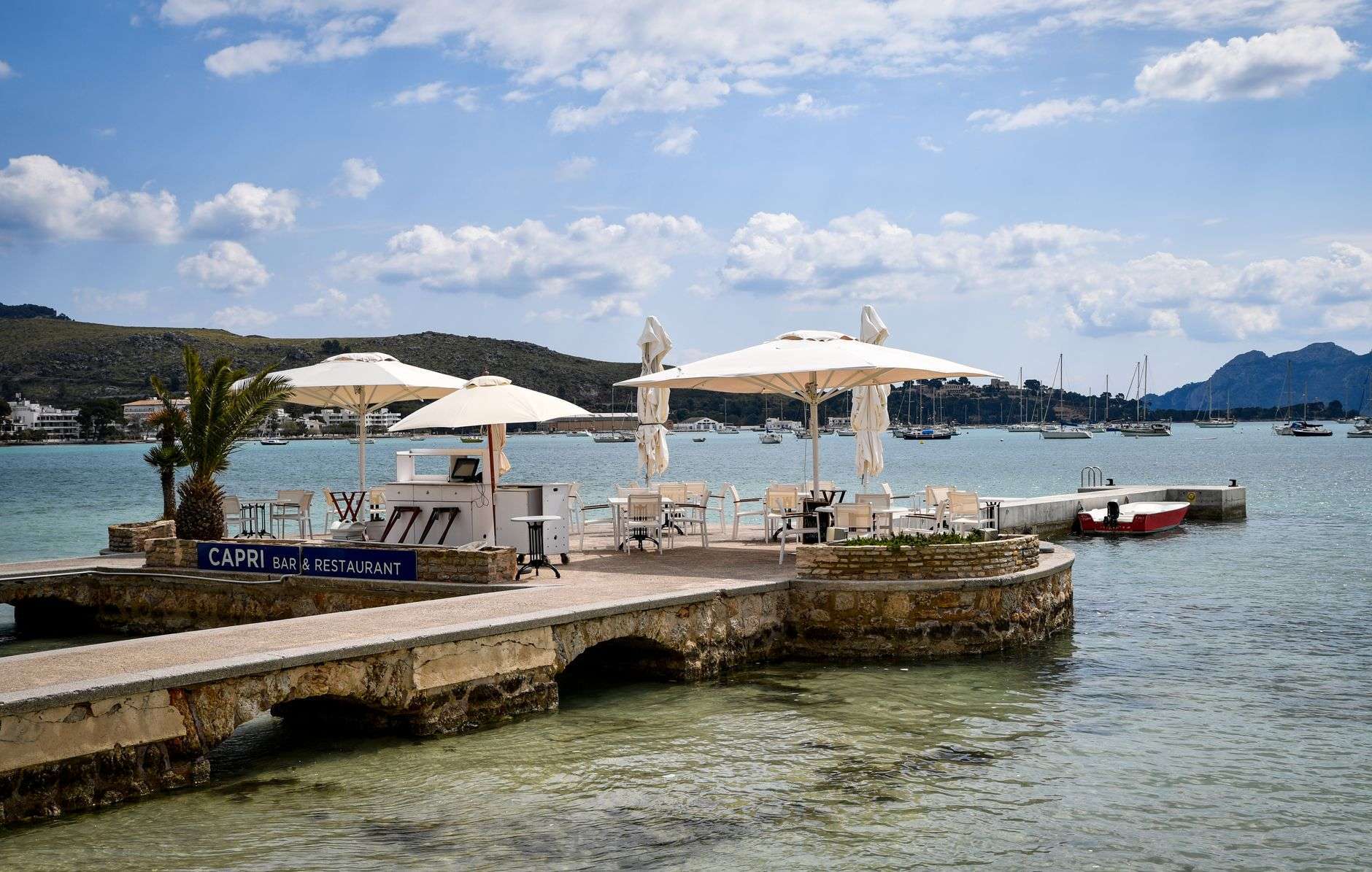 Waterfront restaurant deck overlooking the bay with boats nearby