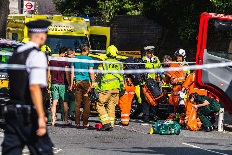 Police and emergency lights illuminate a roadway at the scene of a traffic accident