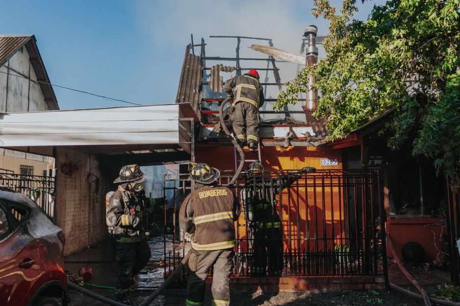 Firefighters working to extinguish a residential house fire