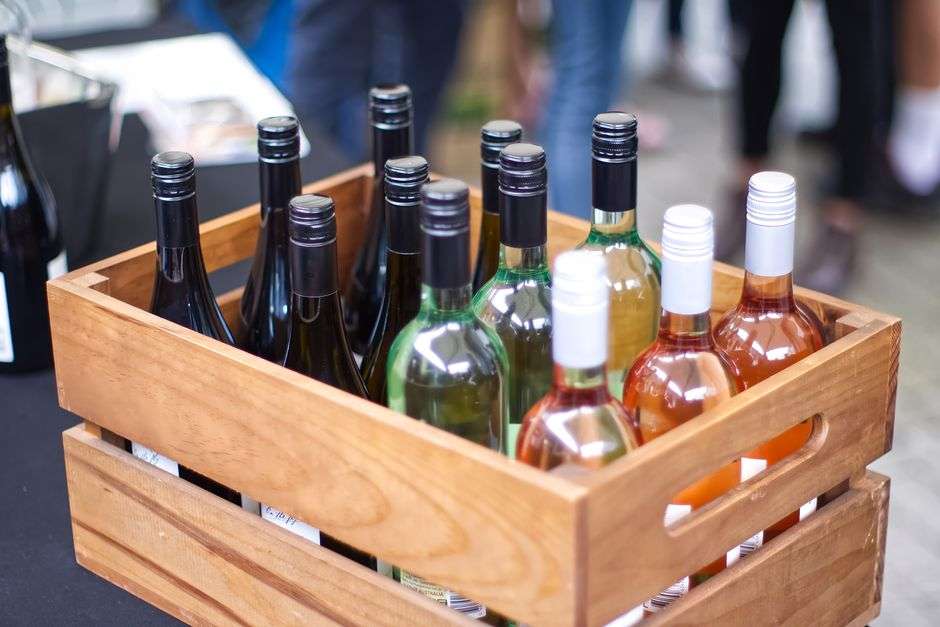A wooden crate filled with bottles of wine, representing wine shipments to consumers