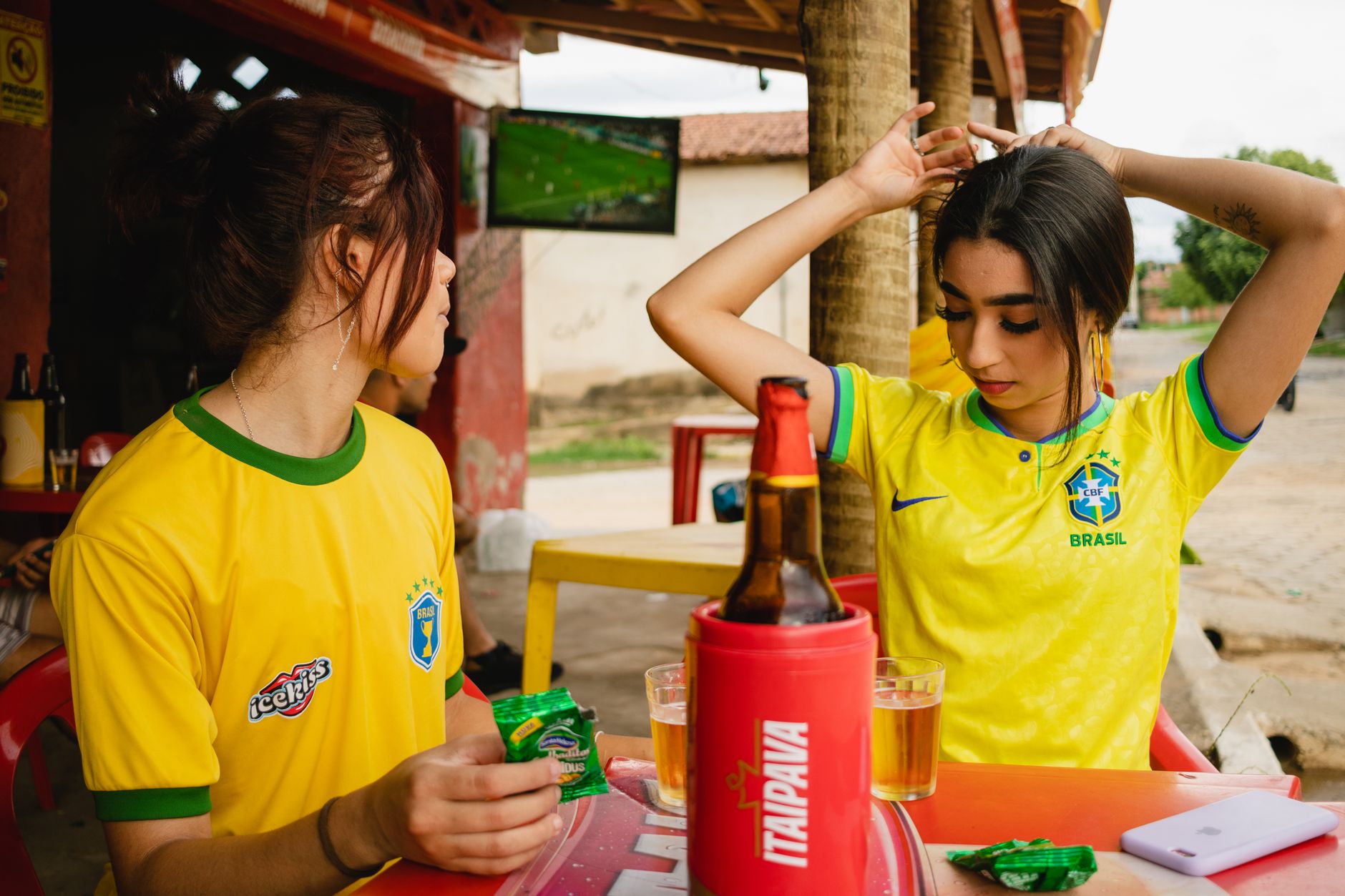 Soccer fans cheering together while watching a match on television