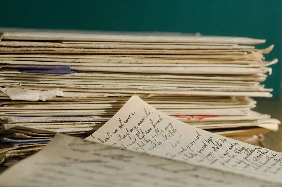 A stack of old handwritten letters tied together, representing historical correspondence