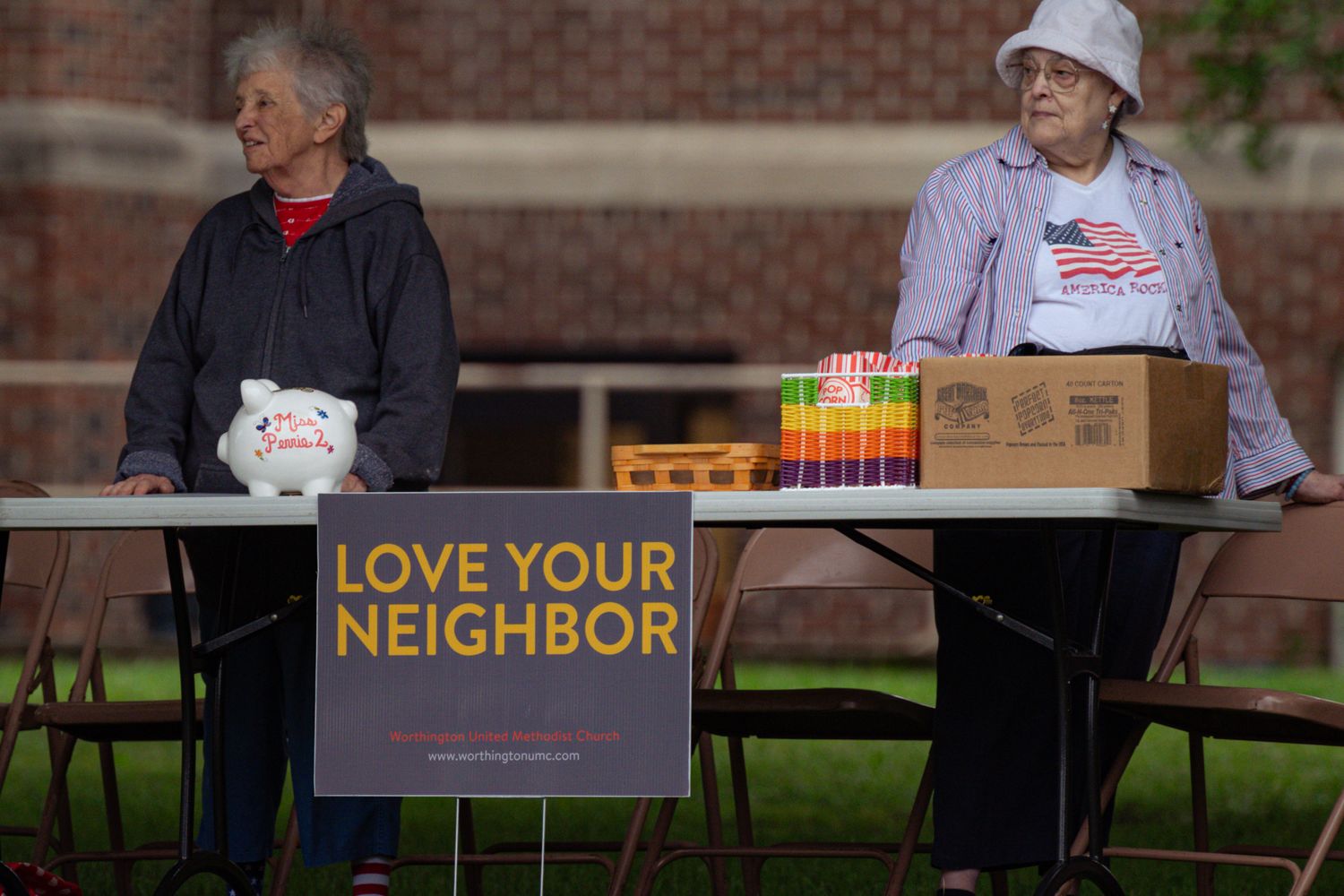 Volunteers preparing tables at a community outreach event in Mobile