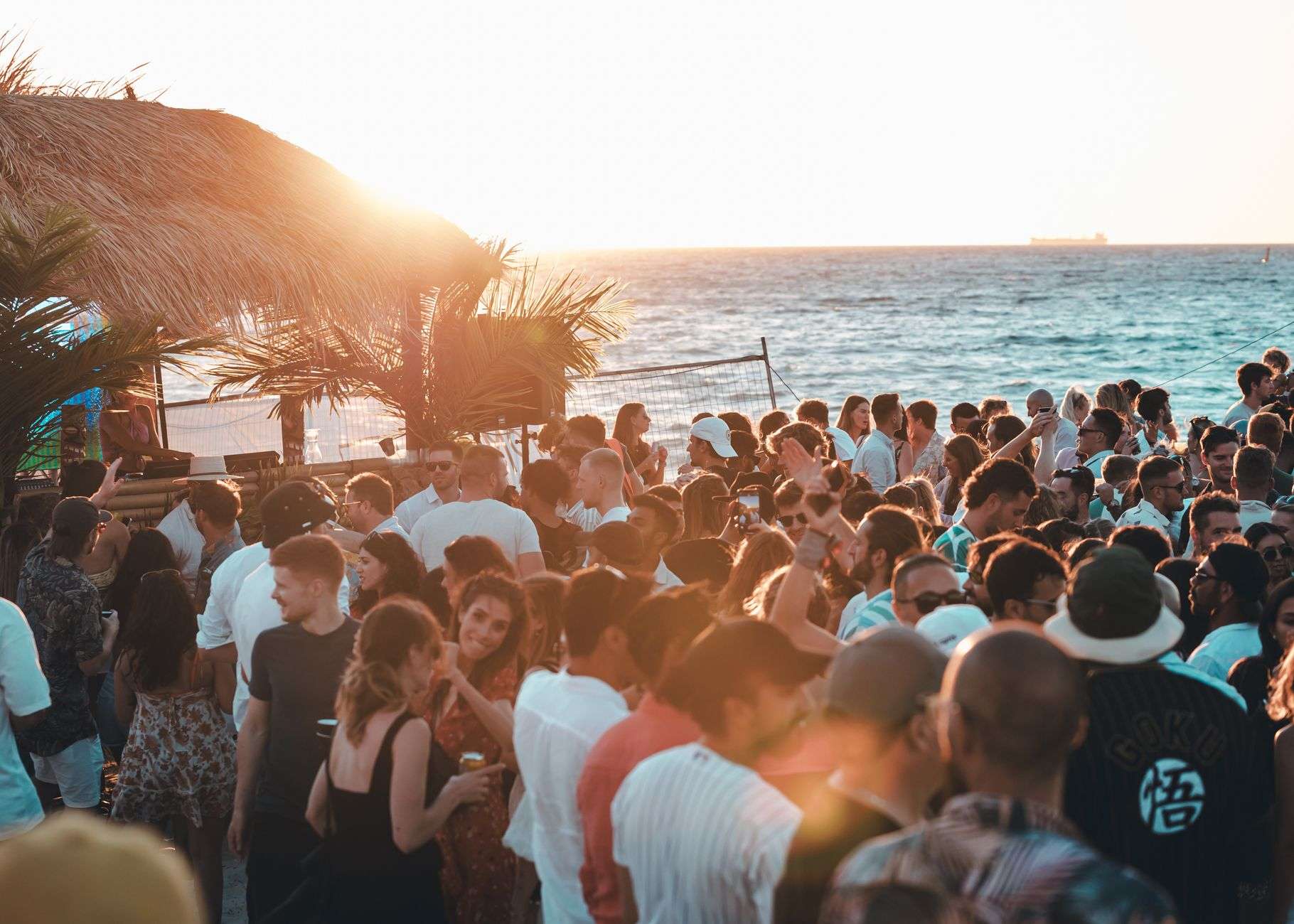 Beachfront bar at sunset with live music