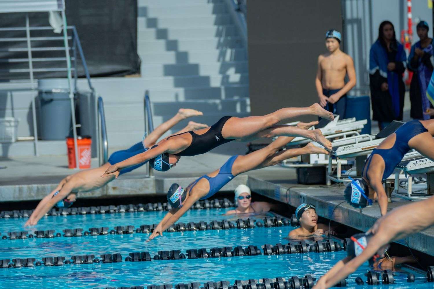 A high school swimmer prepares to dive at a championship meet