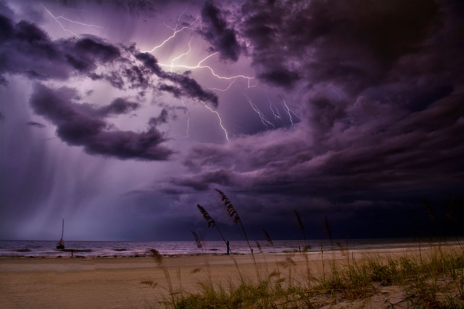 Dark storm clouds building over Gulf of Mexico waters near a beach
