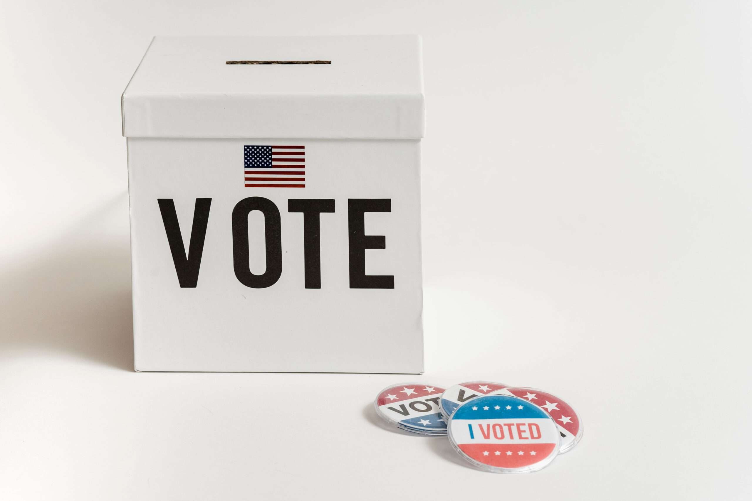 White ballot box with an American flag and I Voted stickers
