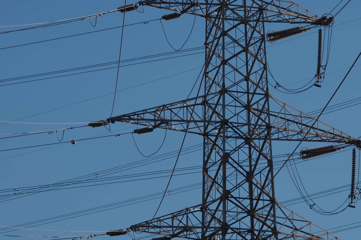 Electrical transmission lines against a cloudy sky