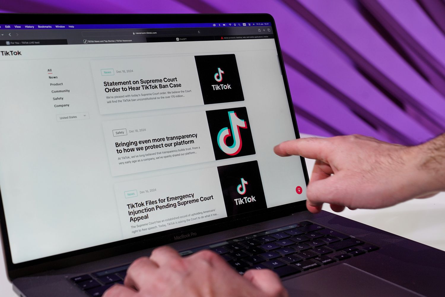 A laptop screen displaying an online news site with article headlines
