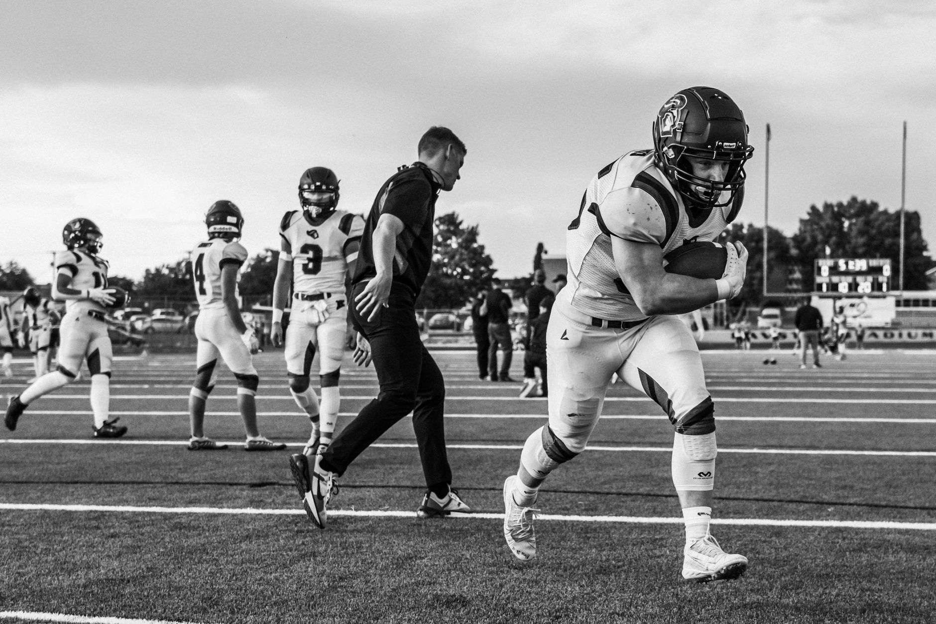 High school football running back carrying the ball during a game