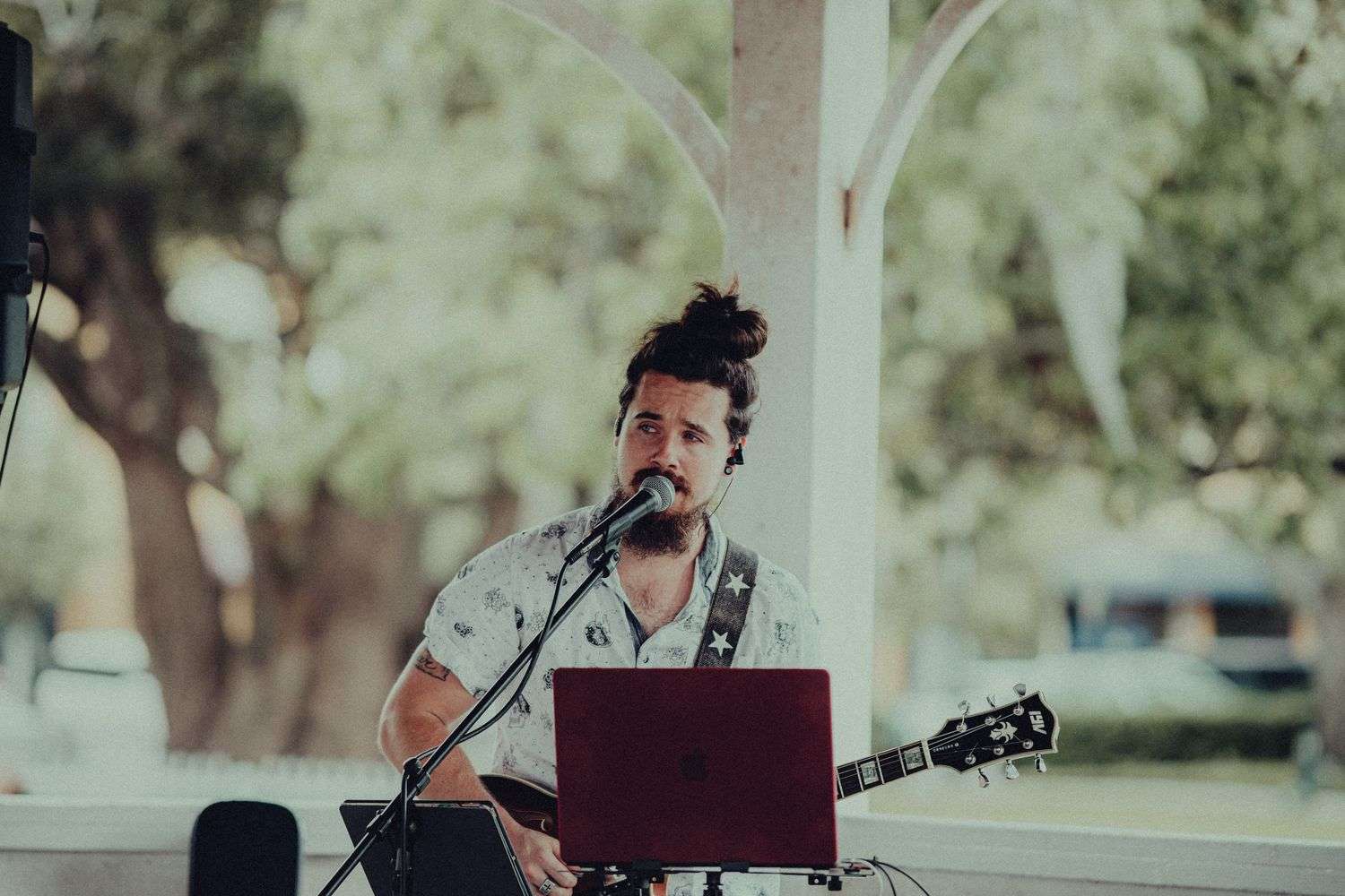 A vocalist and electronic musician performing on stage