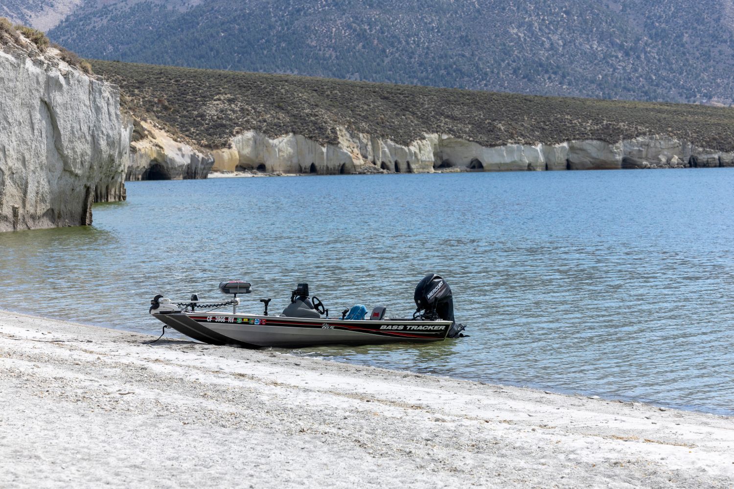 Bass angler fishing from a boat on a calm lake