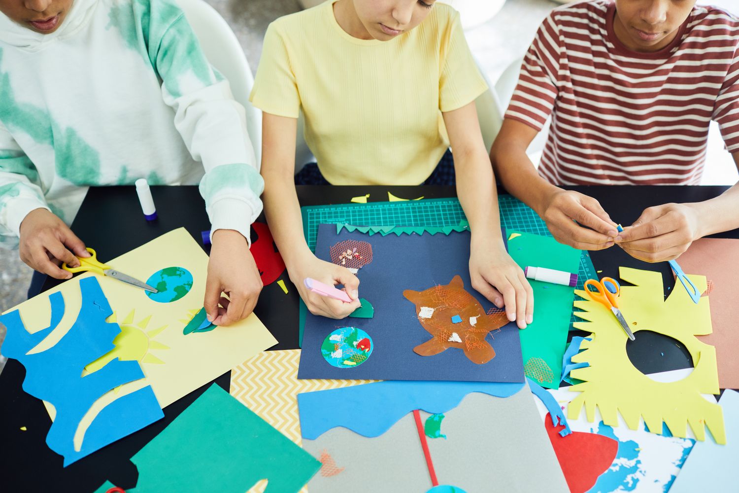 Colorful children's paper collage and craft materials spread on a table
