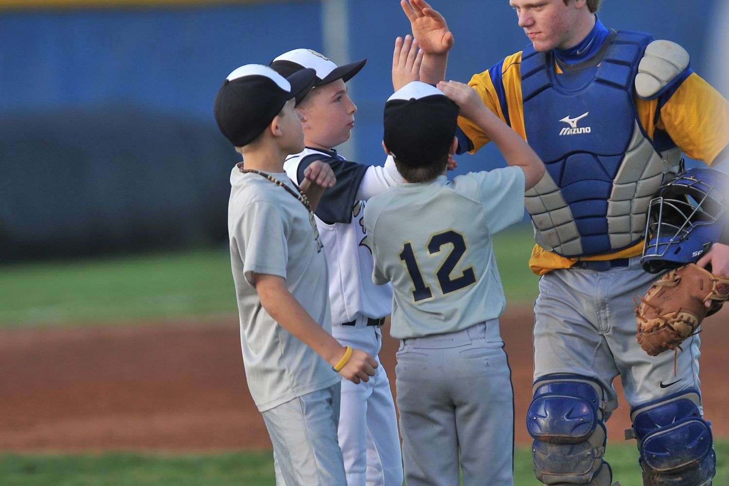 Youth baseball players on a green field