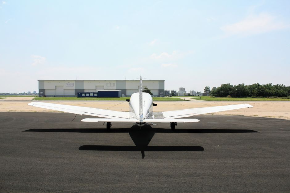 Small aircraft parked near a hangar at a rural Alabama airport