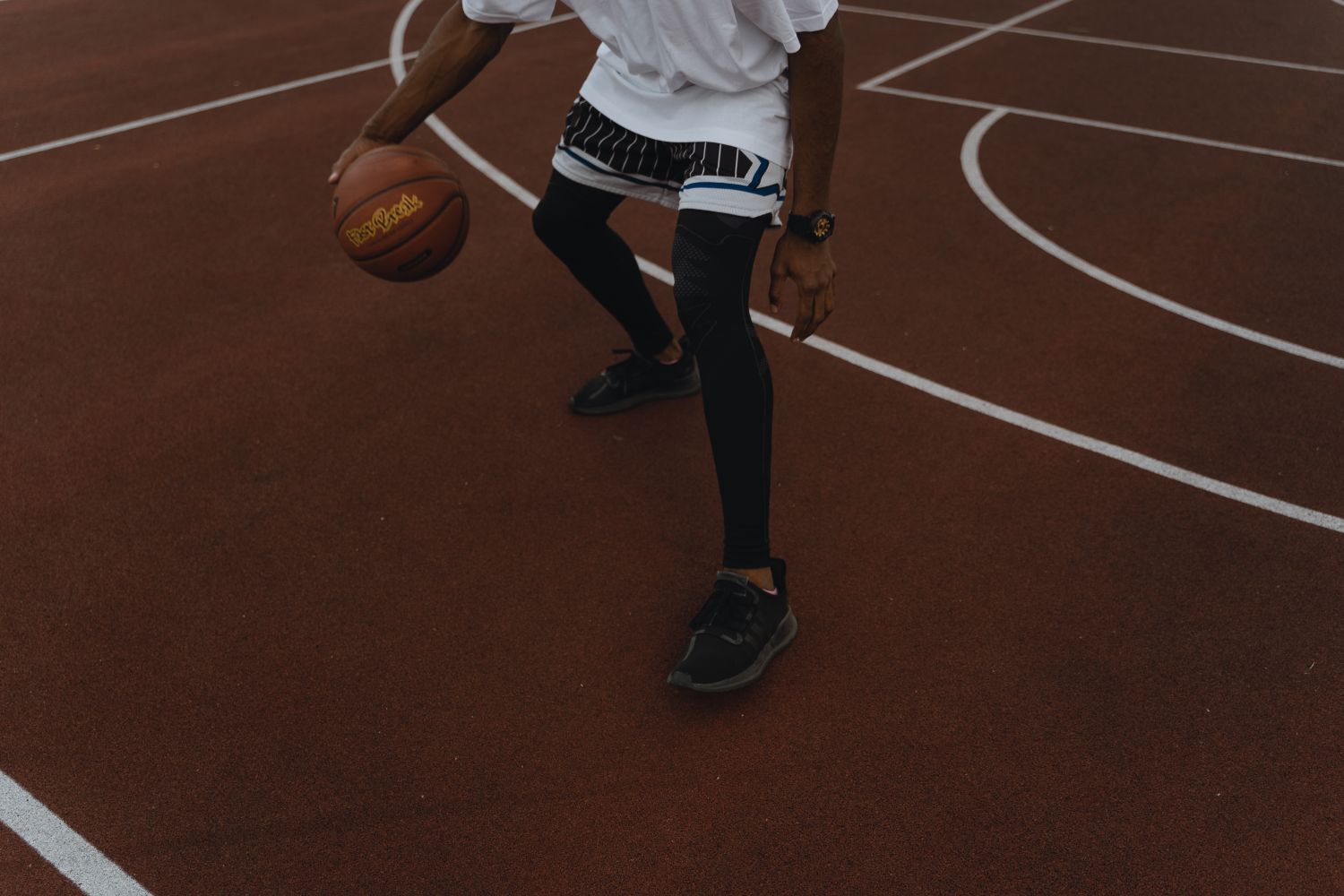 College basketball players compete in front of spectators in an arena