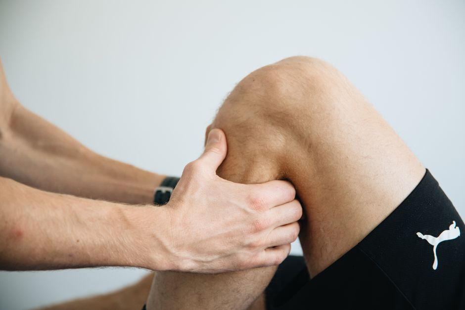 Orthopedic specialist examining a patient's knee