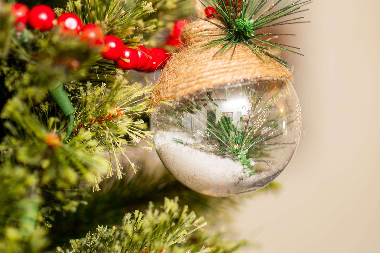 A collectible Christmas ornament hanging on a decorated holiday tree