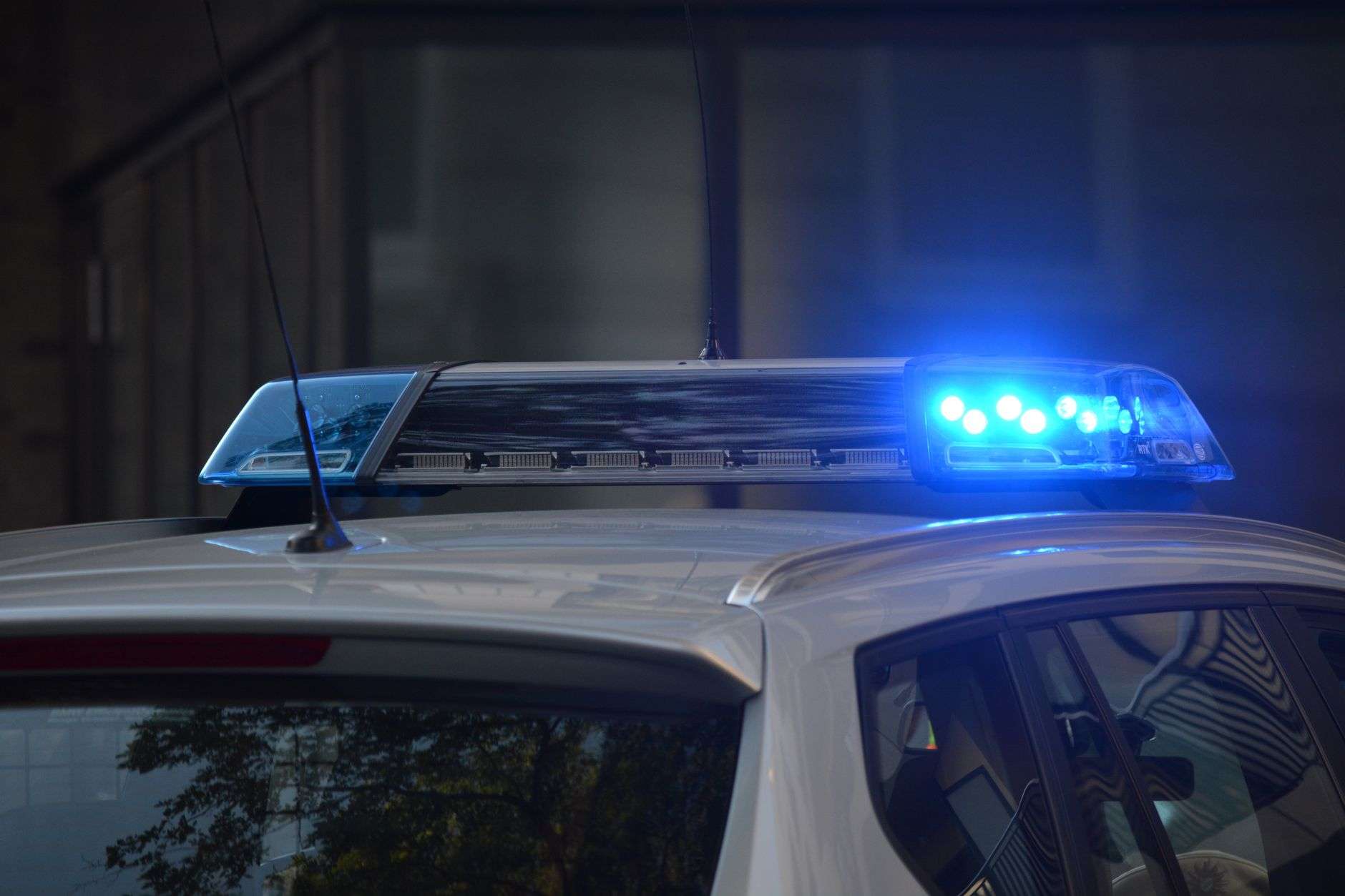 Police emergency lights at night representing a Baldwin County shooting investigation