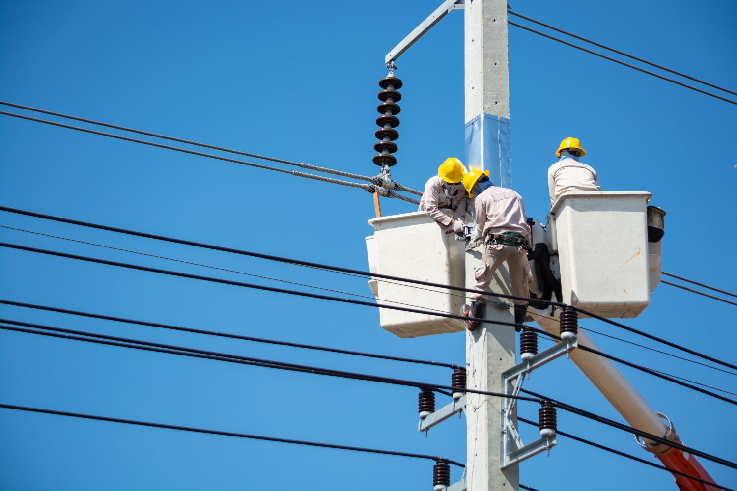 Utility crews working to restore electrical service after an outage