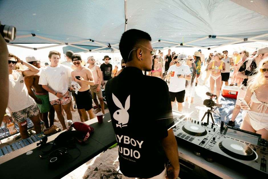 A crowd at an outdoor beach music festival