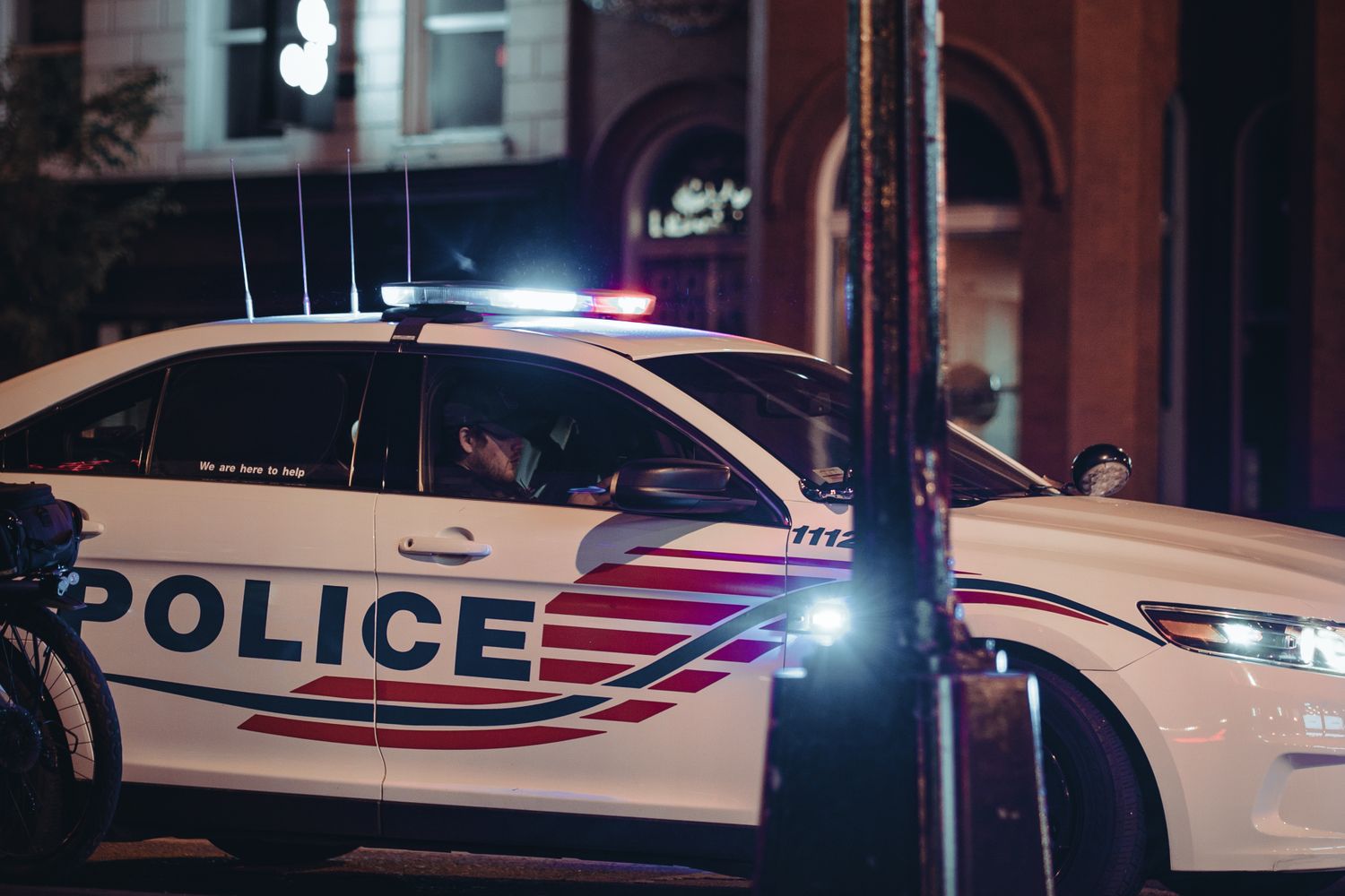 Police vehicle lights on a Mobile street at night