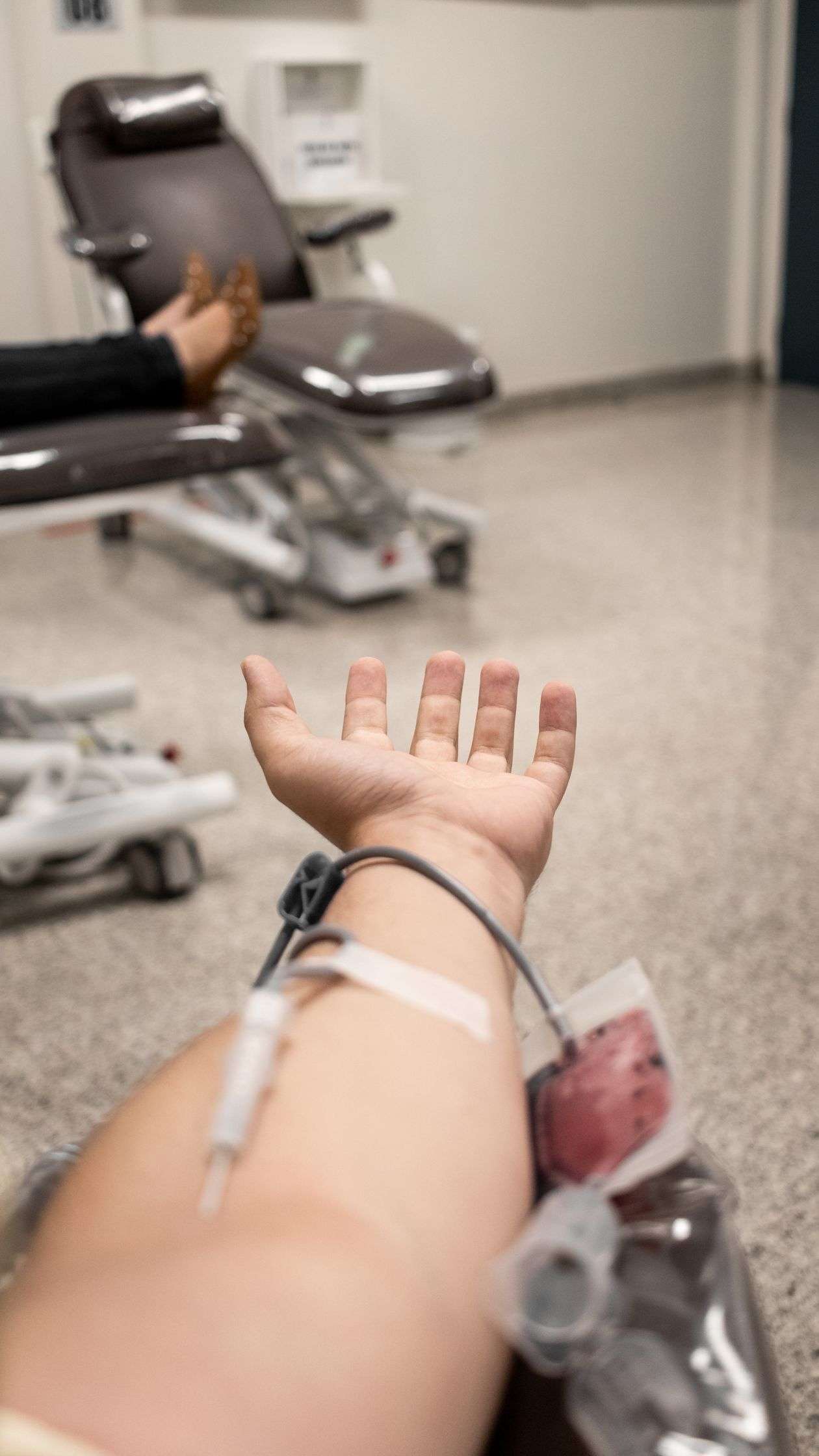 A blood donor giving blood during a community blood drive