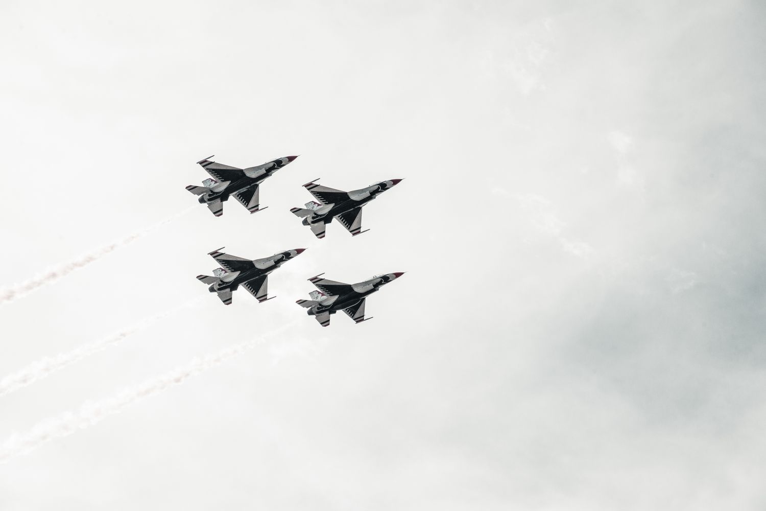 Navy fighter jets flying overhead in formation