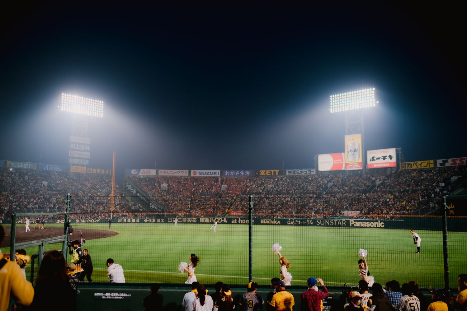 A baseball stadium glowing under night lights
